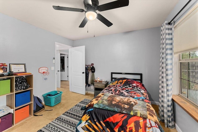 bedroom with ceiling fan and light tile patterned floors