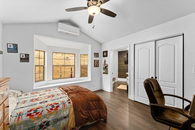 bedroom featuring dark wood-type flooring, a closet, lofted ceiling, ceiling fan, and a wall unit AC