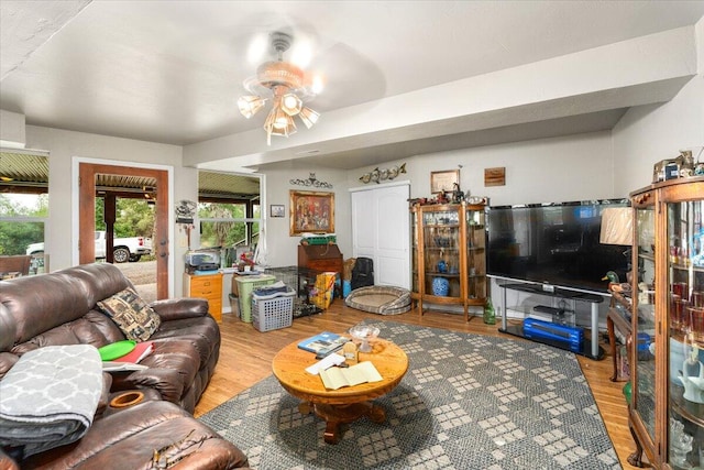 living room with wood-type flooring and ceiling fan