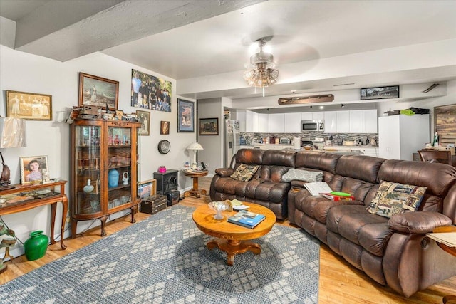 living room with ceiling fan and light hardwood / wood-style floors