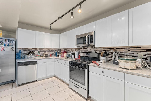 kitchen with stainless steel appliances and white cabinetry