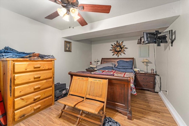 bedroom with ceiling fan and hardwood / wood-style flooring