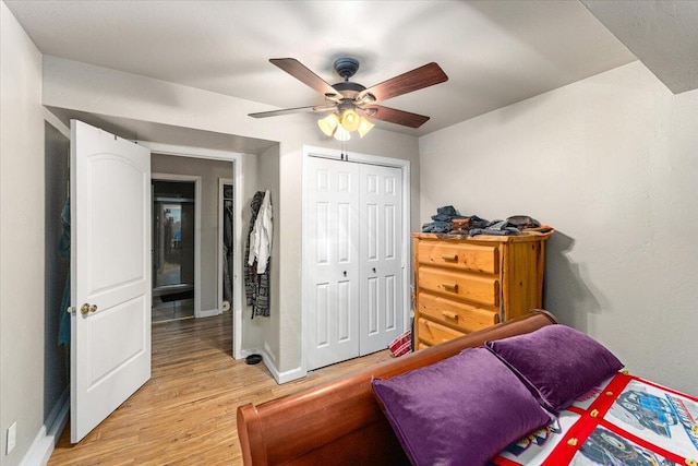 bedroom with light hardwood / wood-style flooring, a closet, and ceiling fan