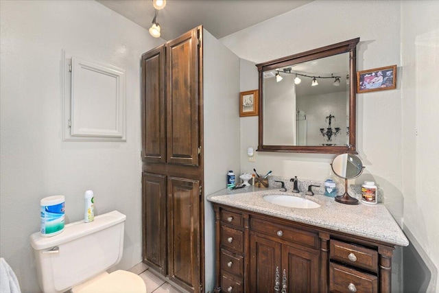 bathroom with tile patterned floors, vanity, and toilet