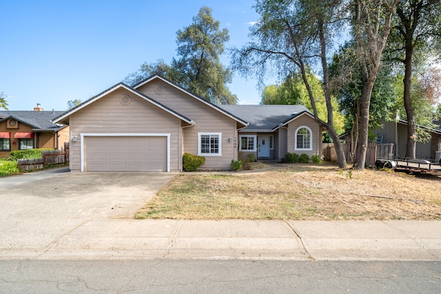 single story home featuring a garage and a front lawn