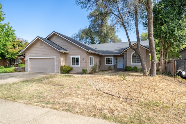 ranch-style house with a front yard and a garage