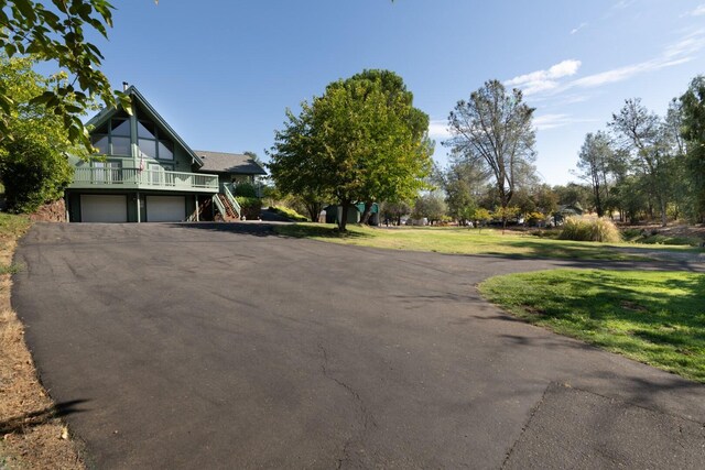 view of property exterior with a yard and a garage