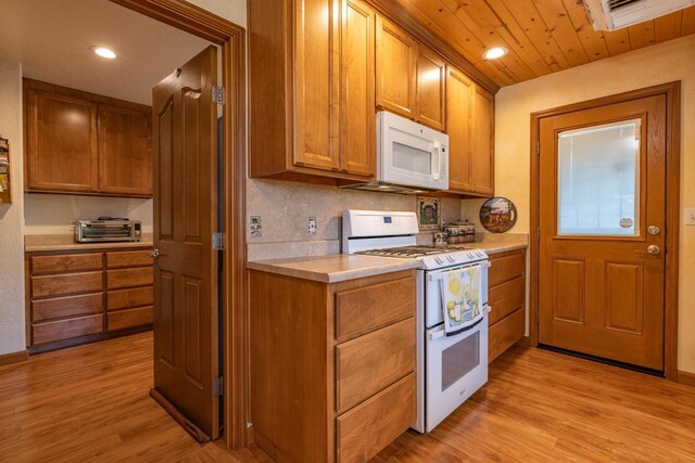 kitchen featuring wood ceiling, light wood-type flooring, white appliances, and tasteful backsplash