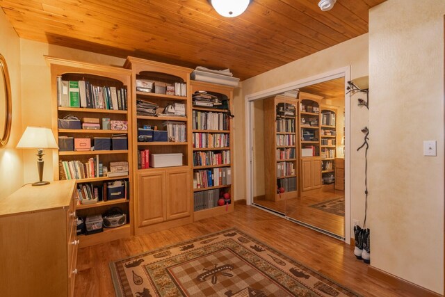 living area featuring light hardwood / wood-style floors and wood ceiling