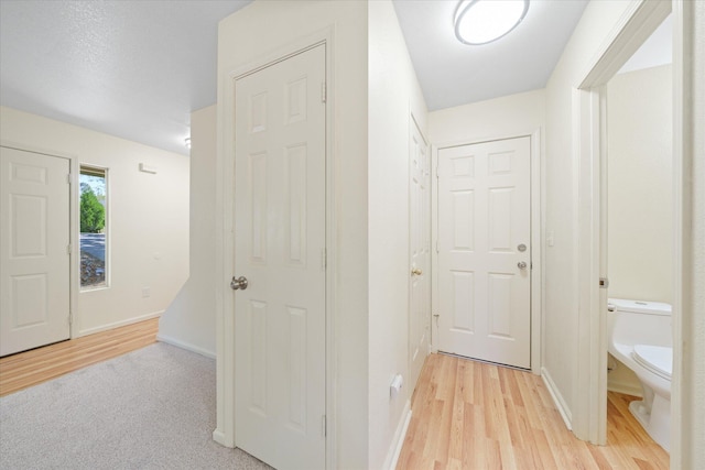 corridor with light hardwood / wood-style flooring