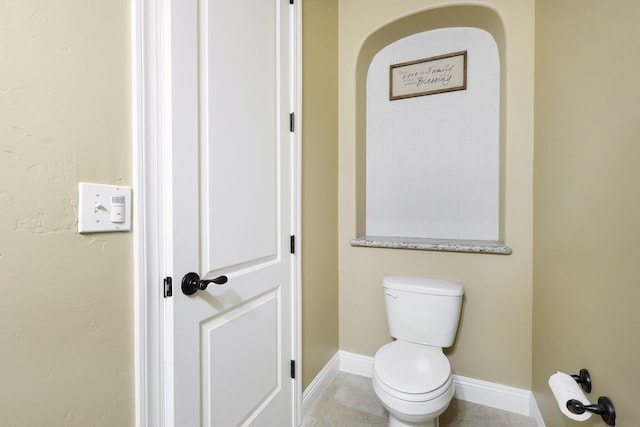 bathroom featuring tile patterned floors and toilet