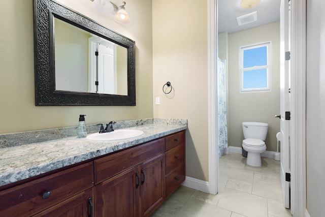 bathroom with tile patterned flooring, vanity, and toilet