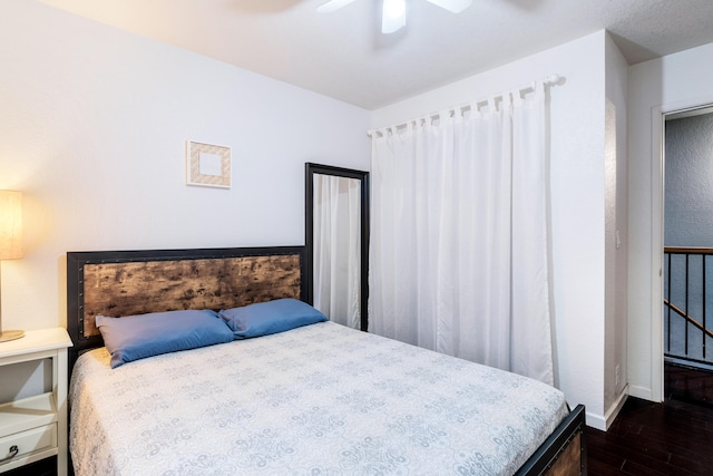 bedroom with ceiling fan and dark hardwood / wood-style floors