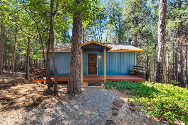 30570 Sleepy Hollow Dr, Shingletown, CA 96088 - view of front of property with board and batten siding and a wooden deck