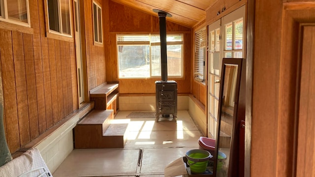 unfurnished sunroom featuring lofted ceiling and a wealth of natural light