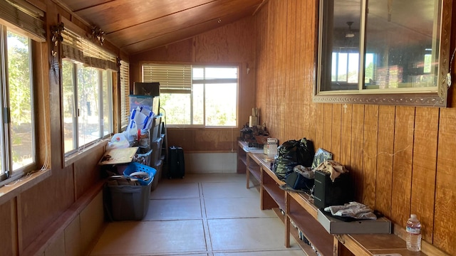 sunroom / solarium featuring lofted ceiling, a healthy amount of sunlight, and wooden ceiling