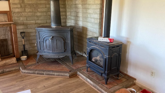 details with hardwood / wood-style flooring and a wood stove