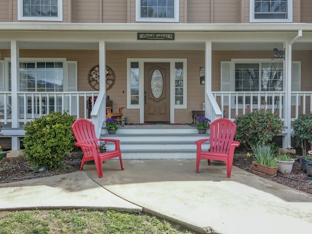 view of exterior entry with covered porch