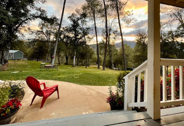 view of community with a lawn and a patio