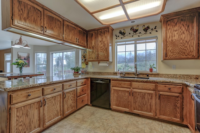 kitchen featuring black dishwasher, sink, kitchen peninsula, and a wealth of natural light