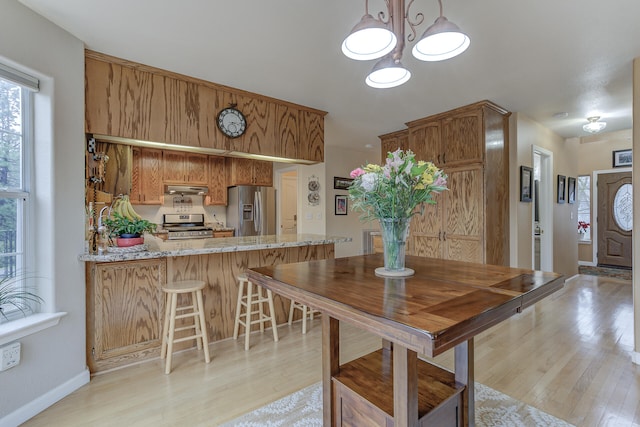 dining space with light hardwood / wood-style floors