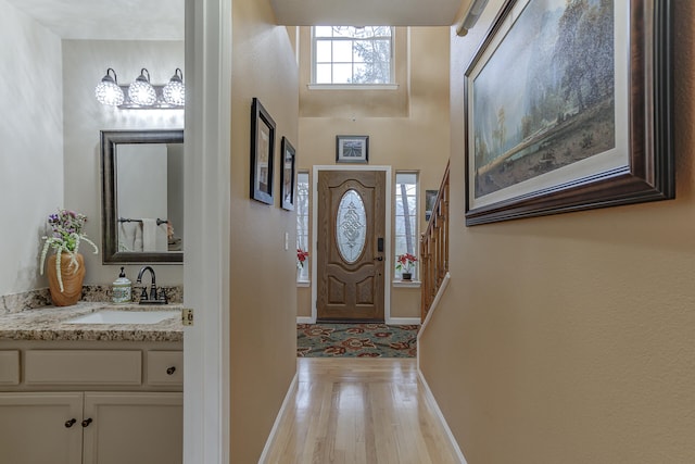 entryway featuring light wood-type flooring and sink