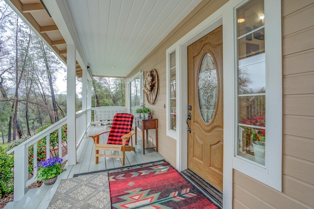 doorway to property featuring covered porch