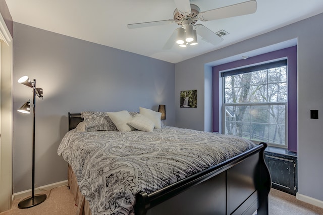 bedroom with ceiling fan and light colored carpet