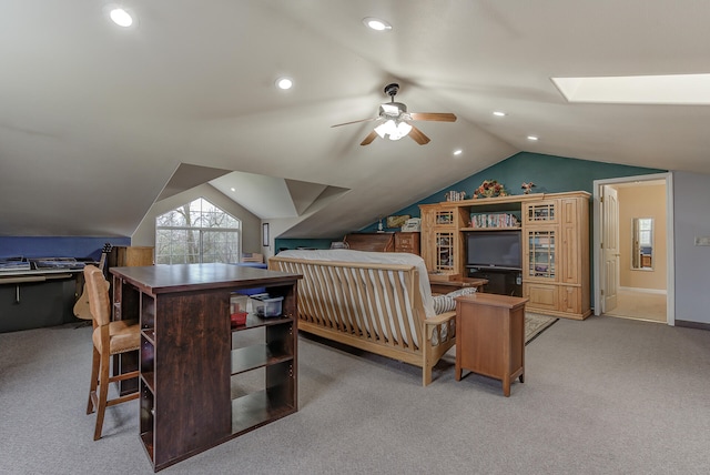 interior space featuring lofted ceiling with skylight and light carpet