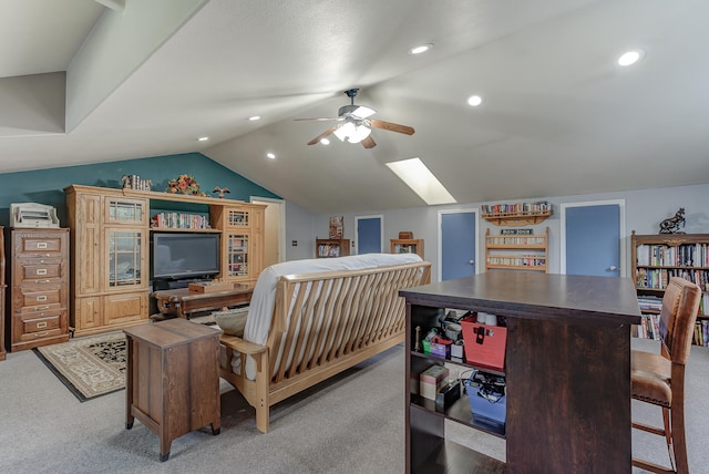 carpeted bedroom featuring vaulted ceiling with skylight