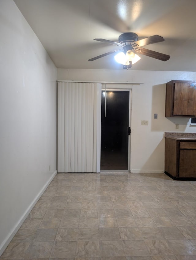 interior space with ceiling fan