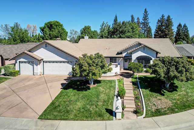 single story home featuring a front lawn and a garage