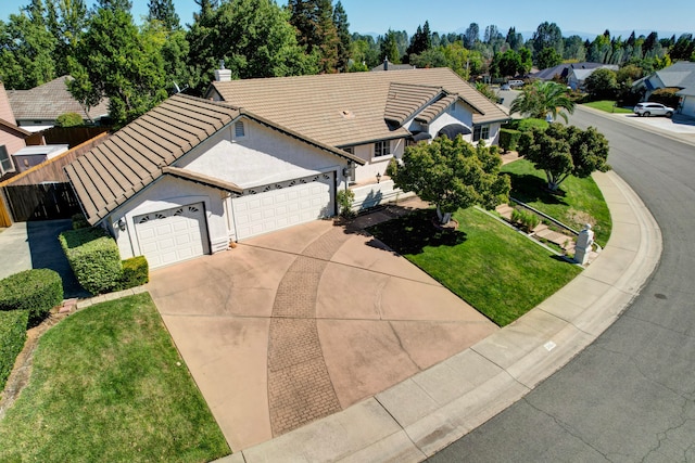 view of front facade with a garage and a front lawn