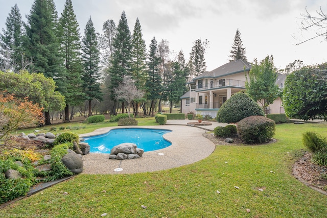 view of pool featuring a lawn and a patio area