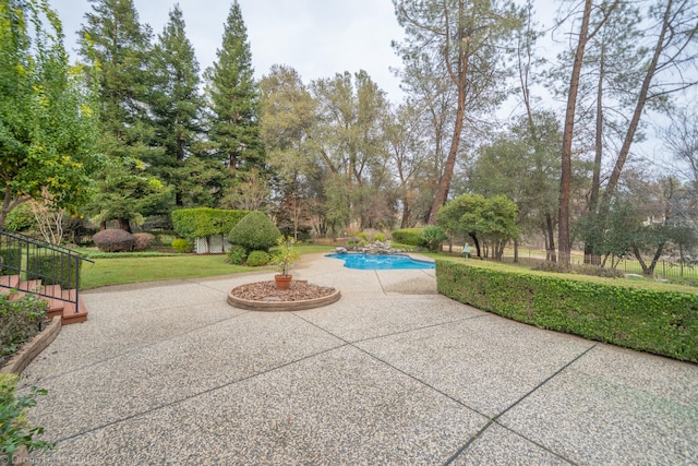 exterior space with a pool and a patio area