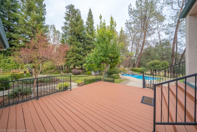 wooden terrace featuring a fenced in pool