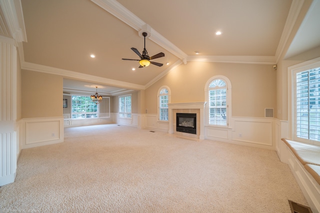 unfurnished living room with vaulted ceiling with beams, ornamental molding, light colored carpet, and a wealth of natural light