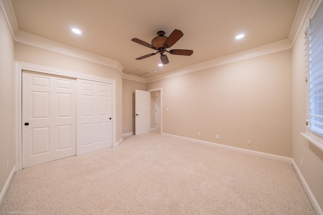 unfurnished bedroom featuring crown molding, ceiling fan, and light colored carpet