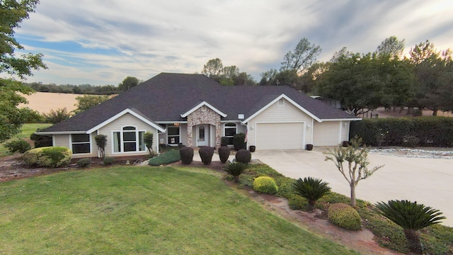 ranch-style home with a yard and a garage