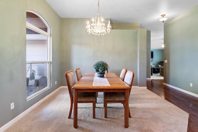 dining room featuring an inviting chandelier and dark hardwood / wood-style flooring