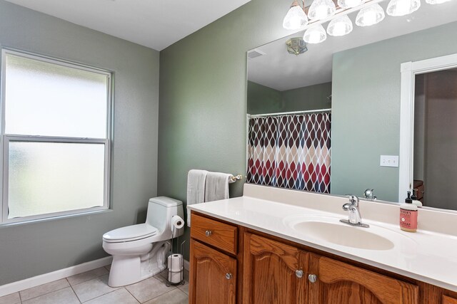 bathroom featuring tile patterned flooring, vanity, and toilet