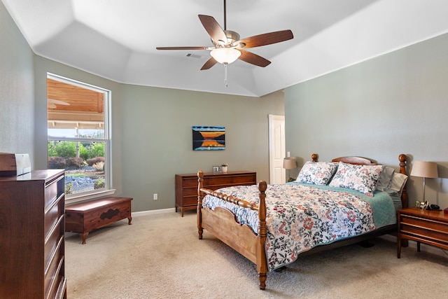 bedroom with lofted ceiling, ceiling fan, and light colored carpet