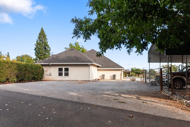 view of side of home with a carport