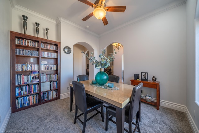 dining area featuring ceiling fan, crown molding, and dark colored carpet