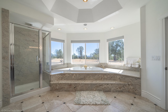 bathroom featuring tile patterned flooring and separate shower and tub