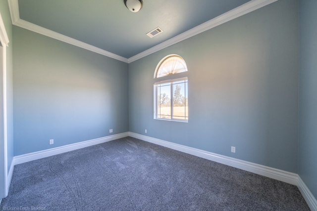 spare room with dark carpet and ornamental molding