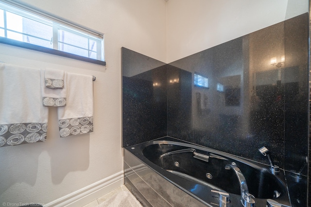 bathroom featuring a washtub and tile patterned floors