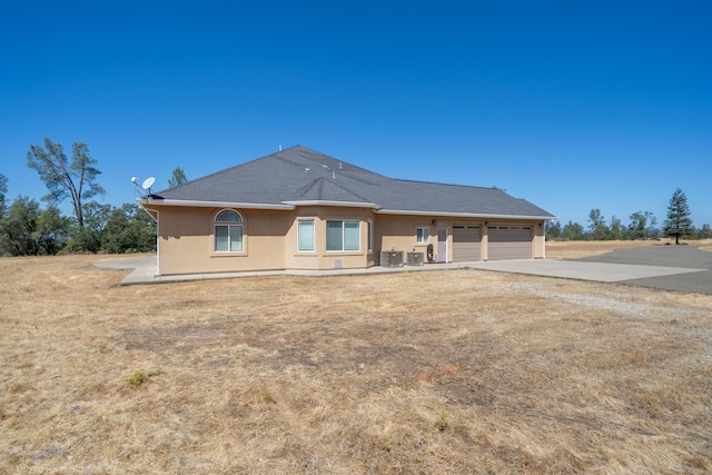 back of property with a garage