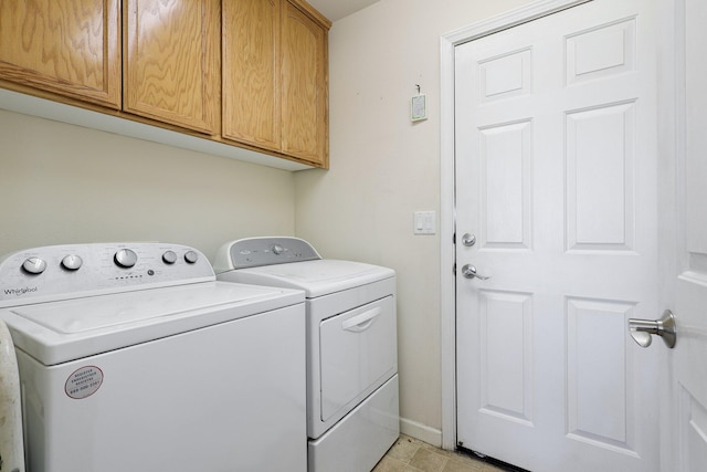 laundry room featuring cabinets and washing machine and dryer