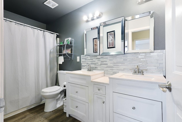 bathroom featuring vanity, wood-type flooring, backsplash, a shower with curtain, and toilet